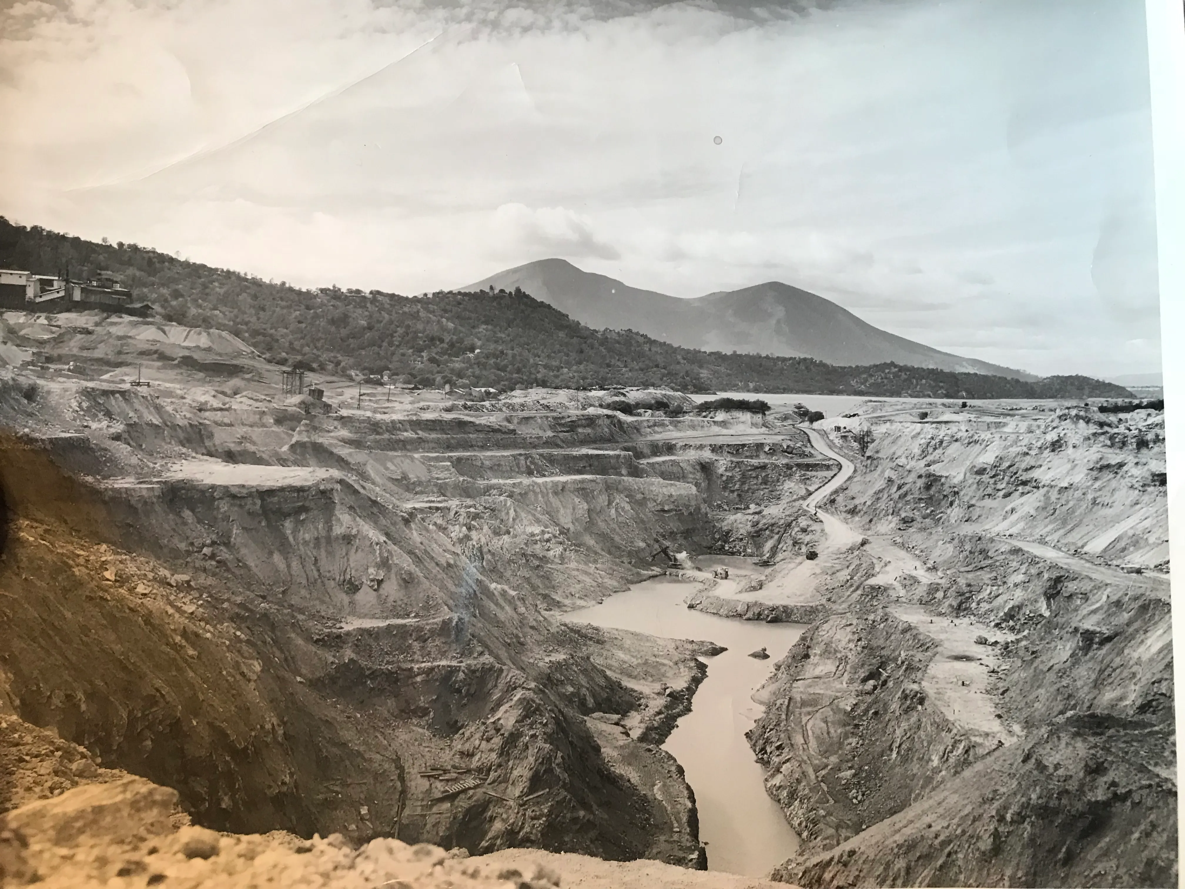 Historical view of the open-pit mercury mine and its terraced benches.