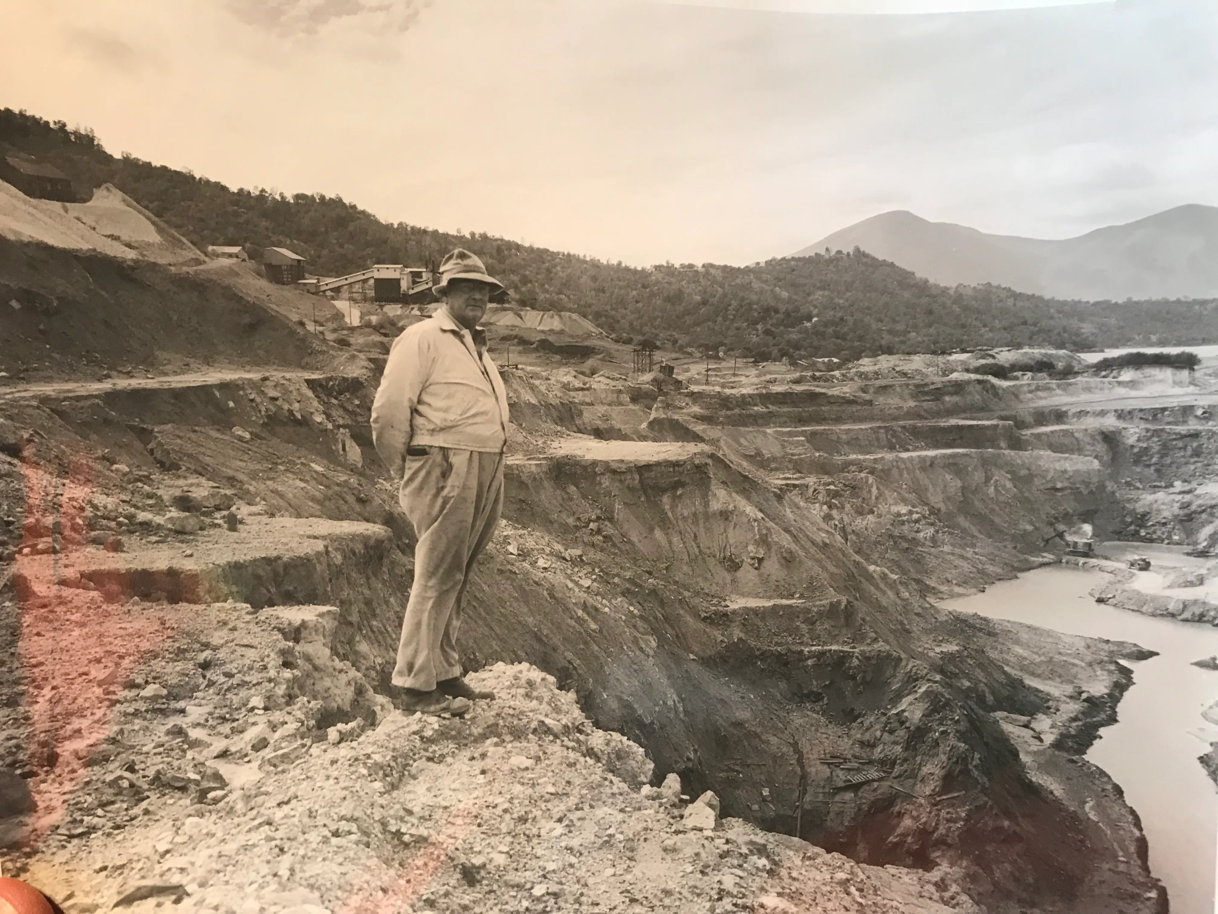 An archival photograph — a figure overlooking the historic mine workings.